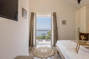 a bedroom with a bed and a window with a view at Villa La Residenza - Heated pool in Podstrana
