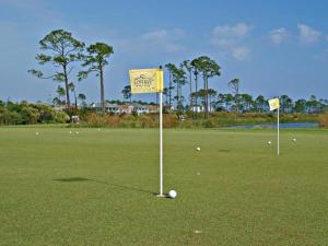 a golf course with two flags on the green at La Salbadora #402C at Lost Key in Perdido Key