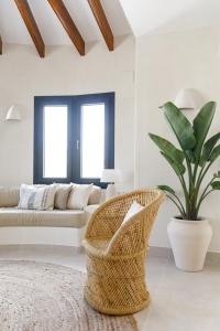 a living room with a couch and a basket at CASA LUZ - Somewhere south villas by Astrid Elisee in Benitachell