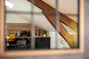 a kitchen with a counter and a table with fruit on it at Major d'Home Amalgame avec jacuzzi en option in Périgueux