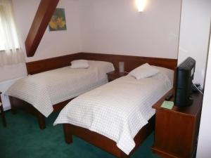 Postel nebo postele na pokoji v ubytování Hotel U Parku