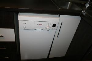 a small white refrigerator and freezer in a kitchen at Penthouse Daniela - 3 Rooms in a Spacious Central Apartment in Târgu-Mureş