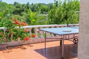 a blue table on a balcony with flowers at Villa Lucas in Pollença