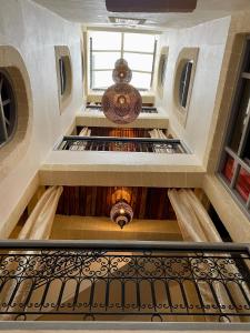 an overhead view of a spiral staircase with a spiral staircase at Dar Farah, riad au coeur de la médina in Essaouira