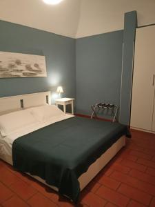 a bedroom with a large bed with a green blanket at C'era una "volta"... un appartamento a Torino in Turin