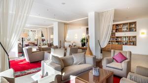 a living room with couches and chairs at Hapimag Apartments Marbella in Marbella