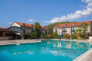 a large swimming pool in front of buildings at Halıcı Hotel Resort & SPA in Pamukkale