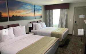 a hotel room with two beds and a large window at Days Inn by Wyndham Bellville Mansfield in Bellville