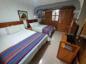 Vuode tai vuoteita majoituspaikassa Hatuchay Inka Apart Hotel