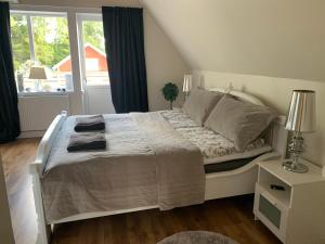 a bedroom with a white bed with a window at Paradise-Silvergruvan in Hällefors