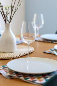 um prato e um copo de vinho sentado numa mesa em 'Elements' 3 bed home in Bracklesham Bay em Chichester