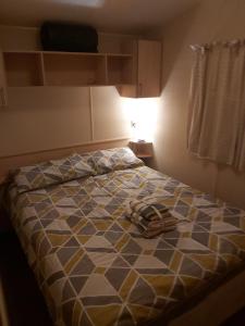 a bed with a pair of shoes sitting on it at Adorable 2 bedroom holiday home in Clacton-on-Sea in Clacton-on-Sea
