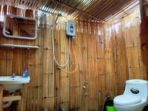 a bathroom with a toilet and a sink at Fundee Story Guesthouse Bamboo House in Chiang mai old town in Chiang Mai
