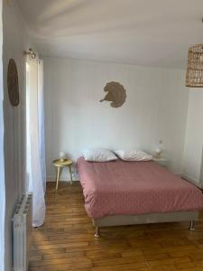 a bedroom with a bed and an elephant on the wall at Quimper: T3 avec vue cathédrale proche gare in Quimper