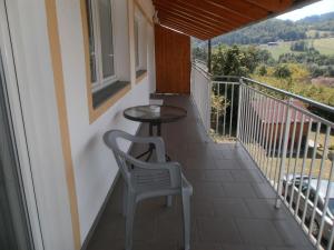 - Balcón con mesa y silla en Ferienanlage am See, en Buchberg bei Herberstein