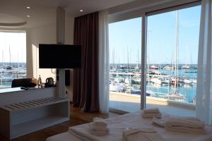 a hotel room with a bed and a view of a marina at Sestante Marina Motel in Capo dʼOrlando