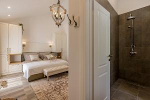 a bedroom with a bed and a walk in shower at Villa La Residenza - Heated pool in Podstrana +115 photos