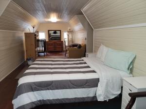 a bedroom with a large bed in a room at Brick House Retreat in Rockingham