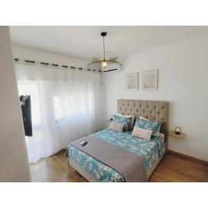 a bedroom with a bed and a television in it at Reis Turismo 2 in Faro