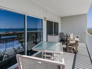 a balcony with a table and chairs and the ocean at Tidewater Orange Beach #202 in Orange Beach