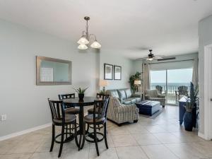 a living room with a table and chairs at Tidewater Orange Beach #202 in Orange Beach
