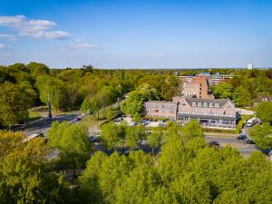 an overhead view of a town with trees and buildings at Bastion Hotel Apeldoorn Het Loo in Apeldoorn