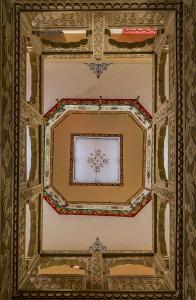 a ceiling of a building with a painting on it at Tripli Hotels Prithvi Palace in Jaisalmer