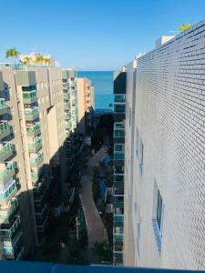 an aerial view of some buildings and the ocean at Apartamento JTR Maceió in Maceió