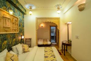 a hotel room with a bed and a bedroom at Tripli Hotels Prithvi Palace in Jaisalmer