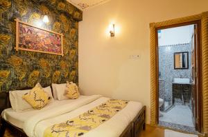 a small bedroom with a bed and a mirror at Tripli Hotels Prithvi Palace in Jaisalmer