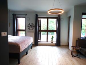 una camera con un letto e due grandi finestre di Bookowska Dal Cuore Apartment a Poznań