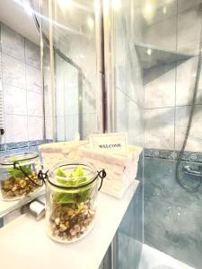 a bathroom counter with a jar of vegetables on it at Apartamenty przy Starówce in Olsztyn +34 photos