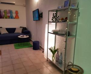 a living room with a blue couch and shelves at Casa Nostra II - Sunny Holiday Stay Near the Beach in Funtana