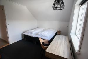 a small room with a bed and a table at The Bird / Guesthouse / 10 min Walk Downtown in Tórshavn