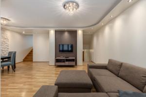 a living room with a couch and a tv at Jekabpils 2 Apartment in Rīga