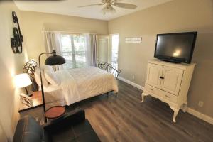 a bedroom with a bed and a flat screen tv at PGA Village Golf Villas I 9808A in Carlton
