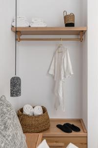 a room with a shelf with towels and a bed at Ammolofos Luxury Apartment & suites in Naxos Chora