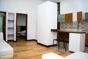 a kitchen with white walls and a counter top at HotelSuizaApartamentos in Ipiales