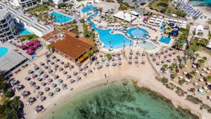 an aerial view of the pool at a resort at Adams Beach Hotel & Spa in Ayia Napa