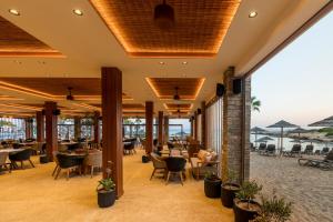 a restaurant with a view of the ocean at Adams Beach Hotel & Spa in Ayia Napa