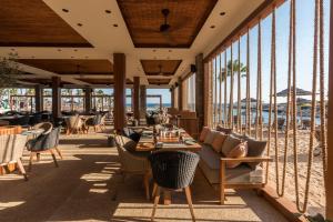 a restaurant with a table and chairs on the beach at Adams Beach Hotel & Spa in Ayia Napa