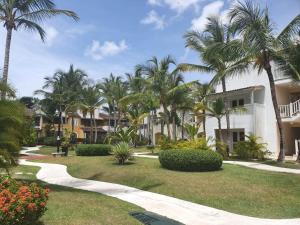 a resort with palm trees and a walkway at Tamarindo in Bayahibe