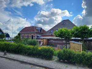 un grupo de casas con plantas frente a una calle en B & B De Tocht en Berkhout