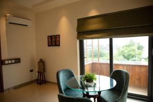 a dining room with a glass table and chairs at Palm Villas in Amritsar