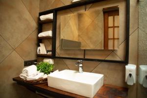 a bathroom with a white sink and a mirror at Palm Villas in Amritsar