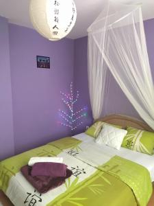a bedroom with a bed and a christmas tree at Sobe Milica Vrnjacka Banja in Vrnjci