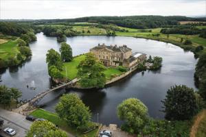 an aerial view of a house on an island in a river at Waterton Park Hotel in Wakefield