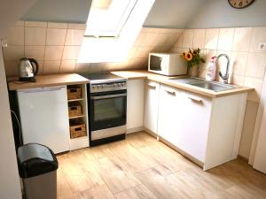 Kuchyň nebo kuchyňský kout v ubytování Apartament Natura