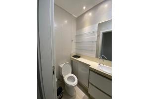 uma casa de banho com um WC e um lavatório em Apto luxo e conforto suíte mais dormitório com churrasqueira em Balneário Camboriú