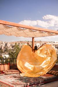 a person in a plastic bag under an umbrella at Goreme Valley Cave House in Goreme